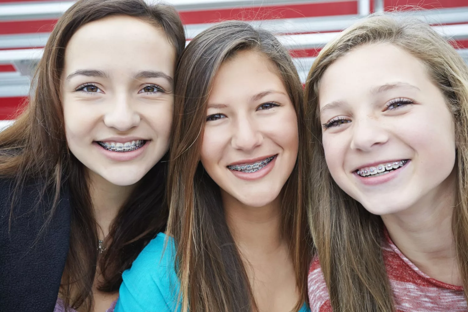 Friends smiling with braces